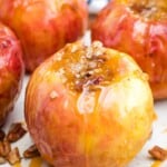 Grilled Baked Apples with caramel and nuts on a white plate