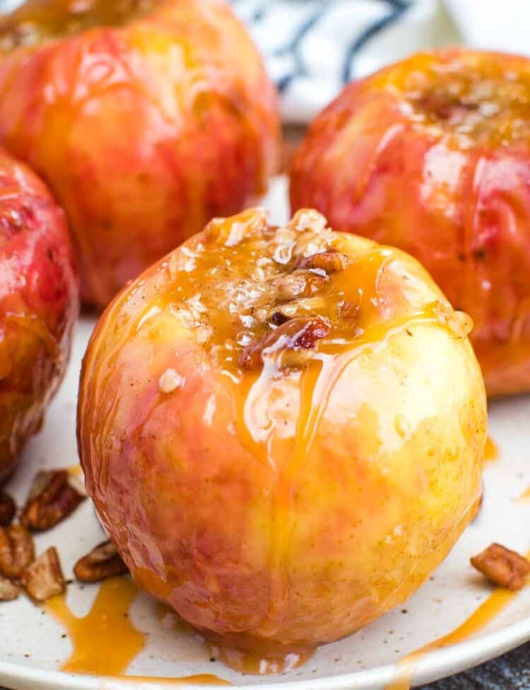 Grilled Baked Apples with caramel and nuts on a white plate