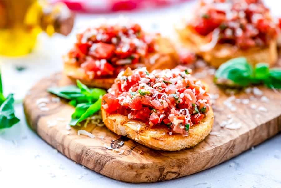 Piece of Bruschetta on a wood board.