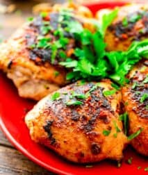 Grilled Chicken Thighs on red plate