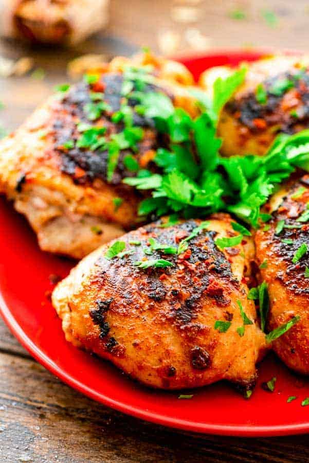 Grilled Chicken Thighs on red plate