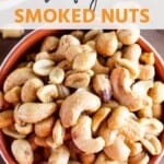 Traeger smoked nuts mix in a white and red bowl.