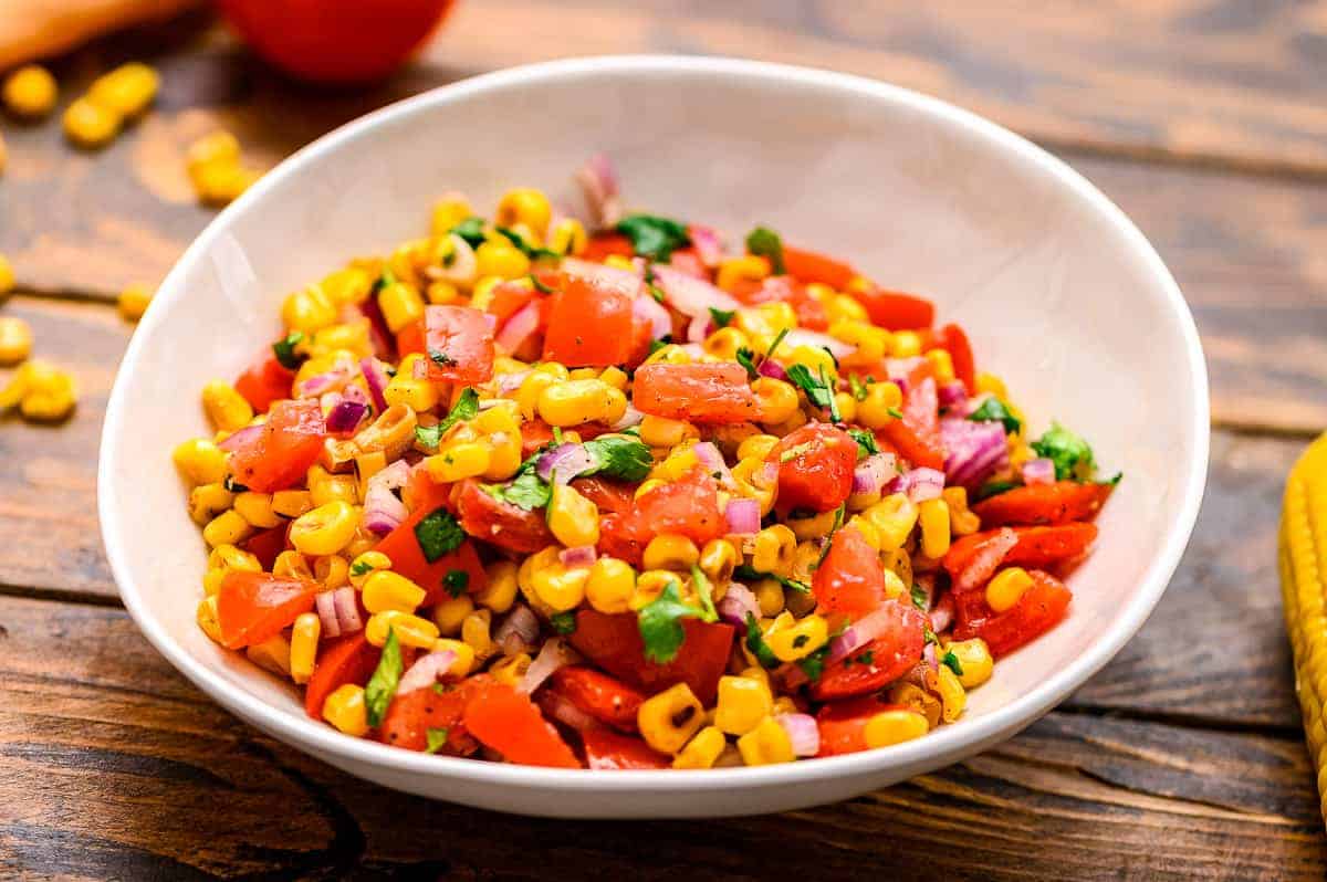 Bowl of salsa made with corn cilantro tomatoes onions