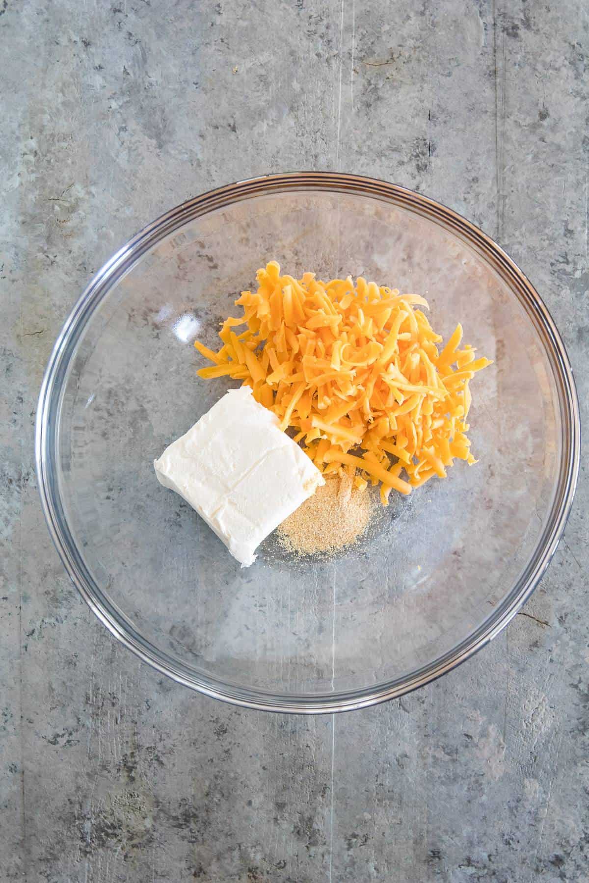 Glass Bowl with cream cheese, garlic powder and grated cheddar cheese