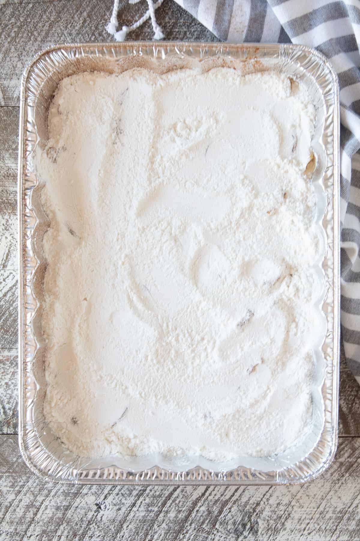 Aluminum foil pan with dry cake mix in it.