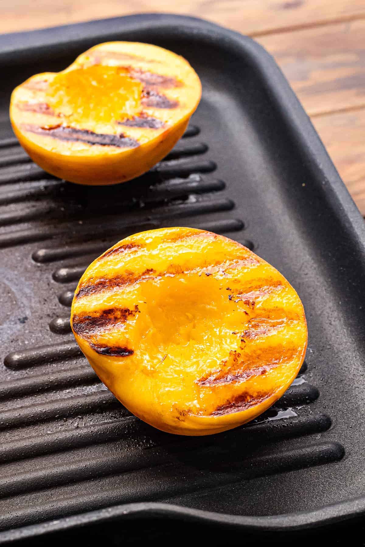 Peaches with grill marks laying on grill pan