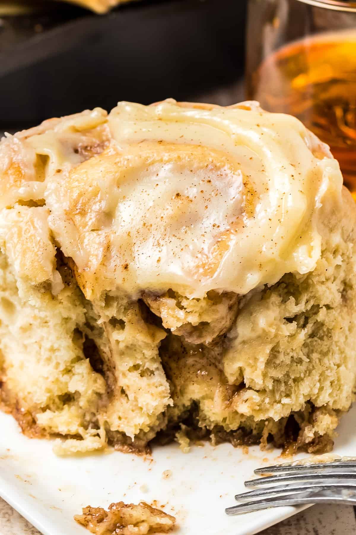 Frosted Cinnamon Roll with a bite gone
