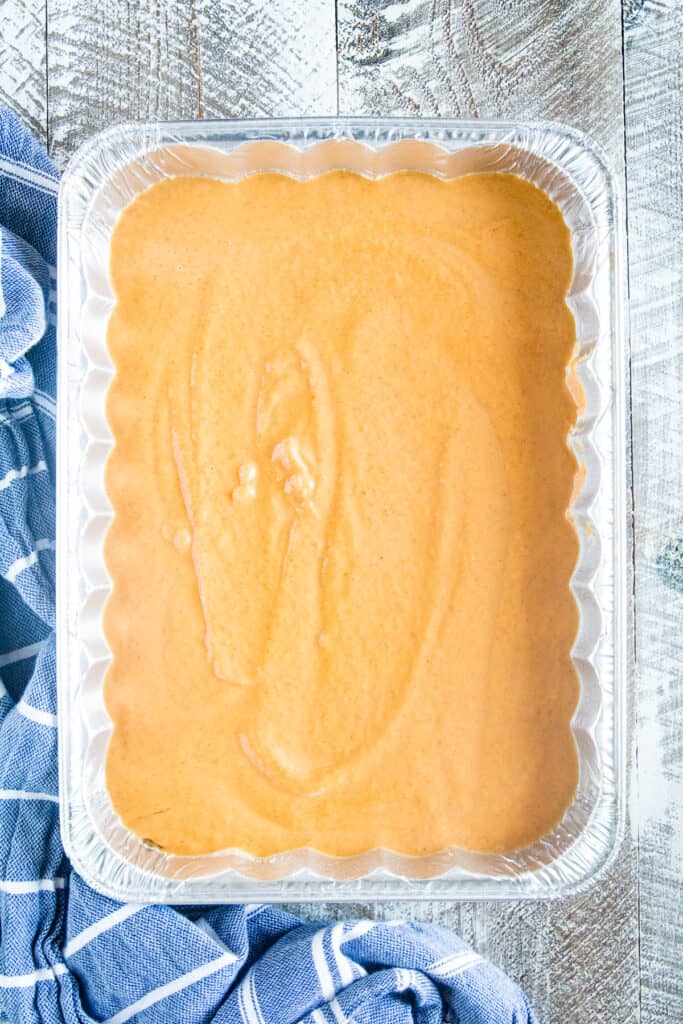 Pumpkin Dump Cake batter in disposable aluminum pan