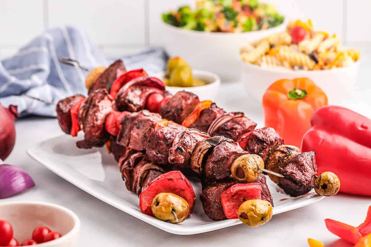 A white plate with a stack of Sirloin Steak Kabobs