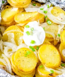 Foil Packet with potatoes and onions topped with sour cream dallop