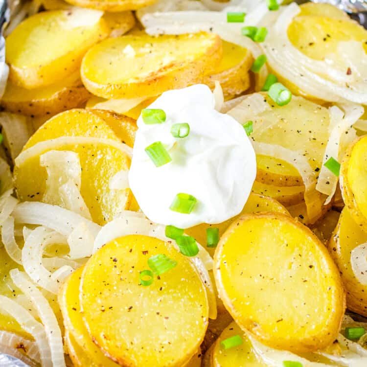 Foil Packet with potatoes and onions topped with sour cream dallop