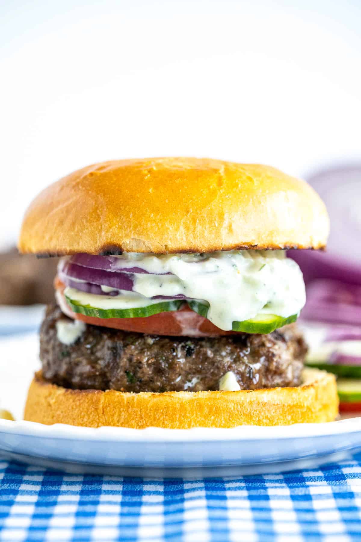 Greek Burger topped with Tzatzki Sauce on bun