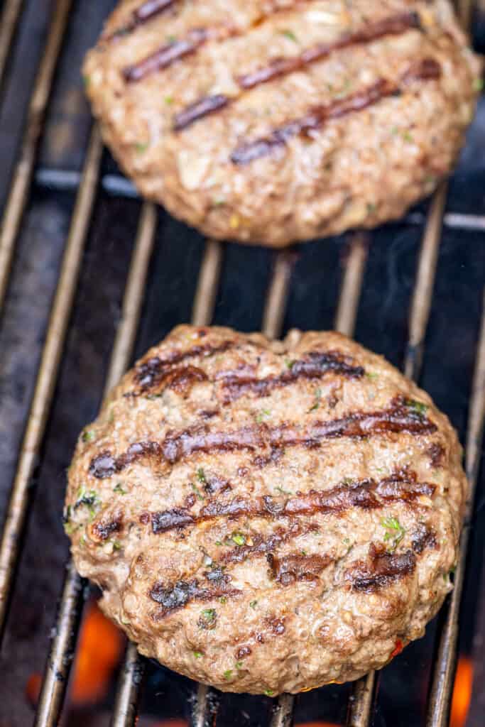 Burger on grill grates with grilling marks
