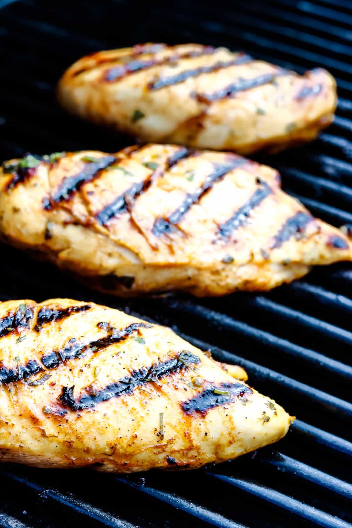 Chicken breasts on grill with grill marks