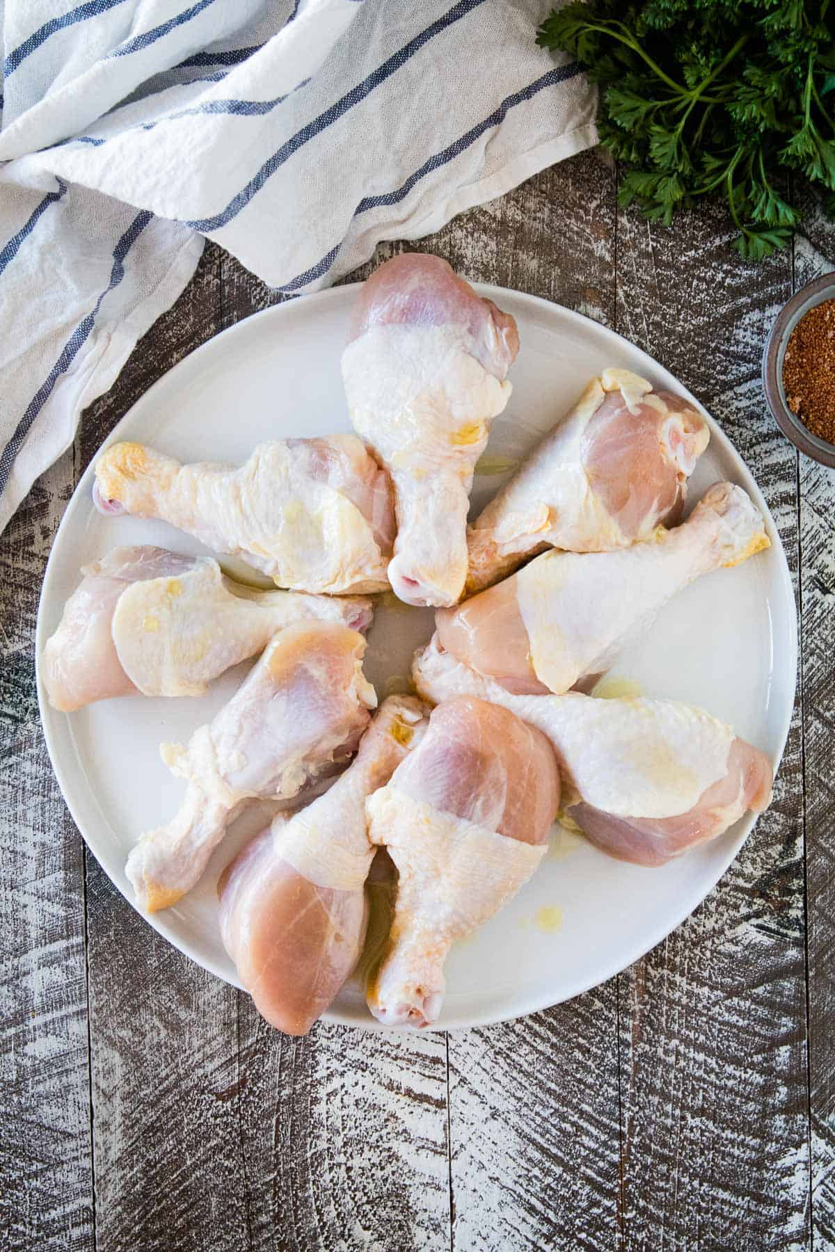 Plate of chicken legs with olive oil