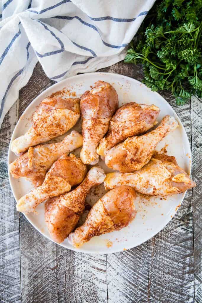 Plate of seasoned chicken legs on plate