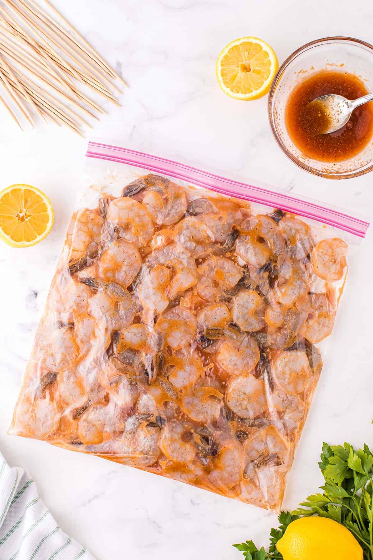 A ziploc bag with shrimp in a spicy marinade