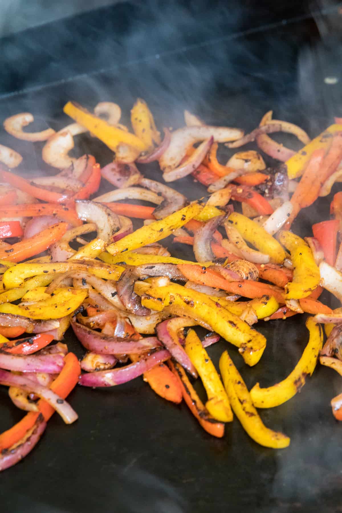 Fajita vegetables cooked on outdoor griddle