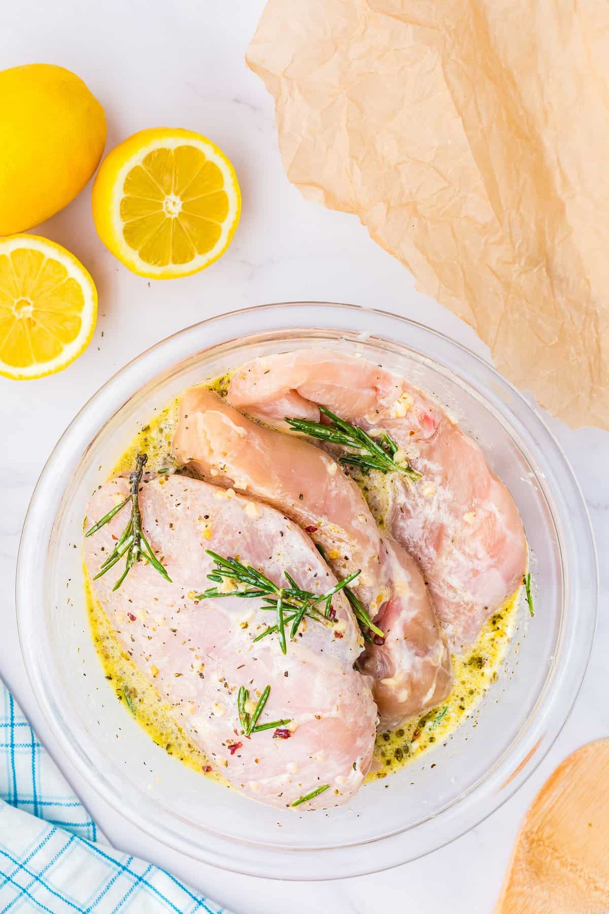 Chicken breasts with lemon marinade in bowl