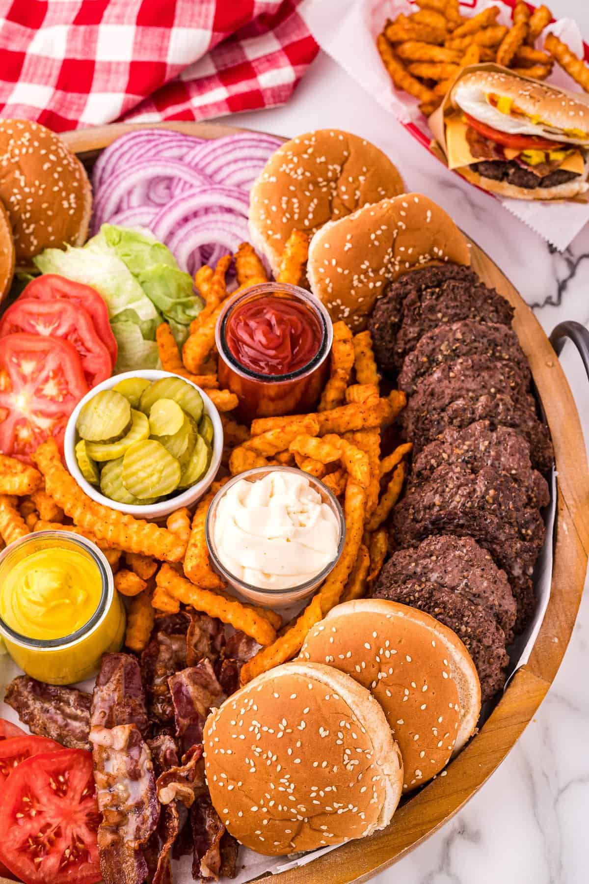 Overhead image of burger board with condiments, burgers and toppings
