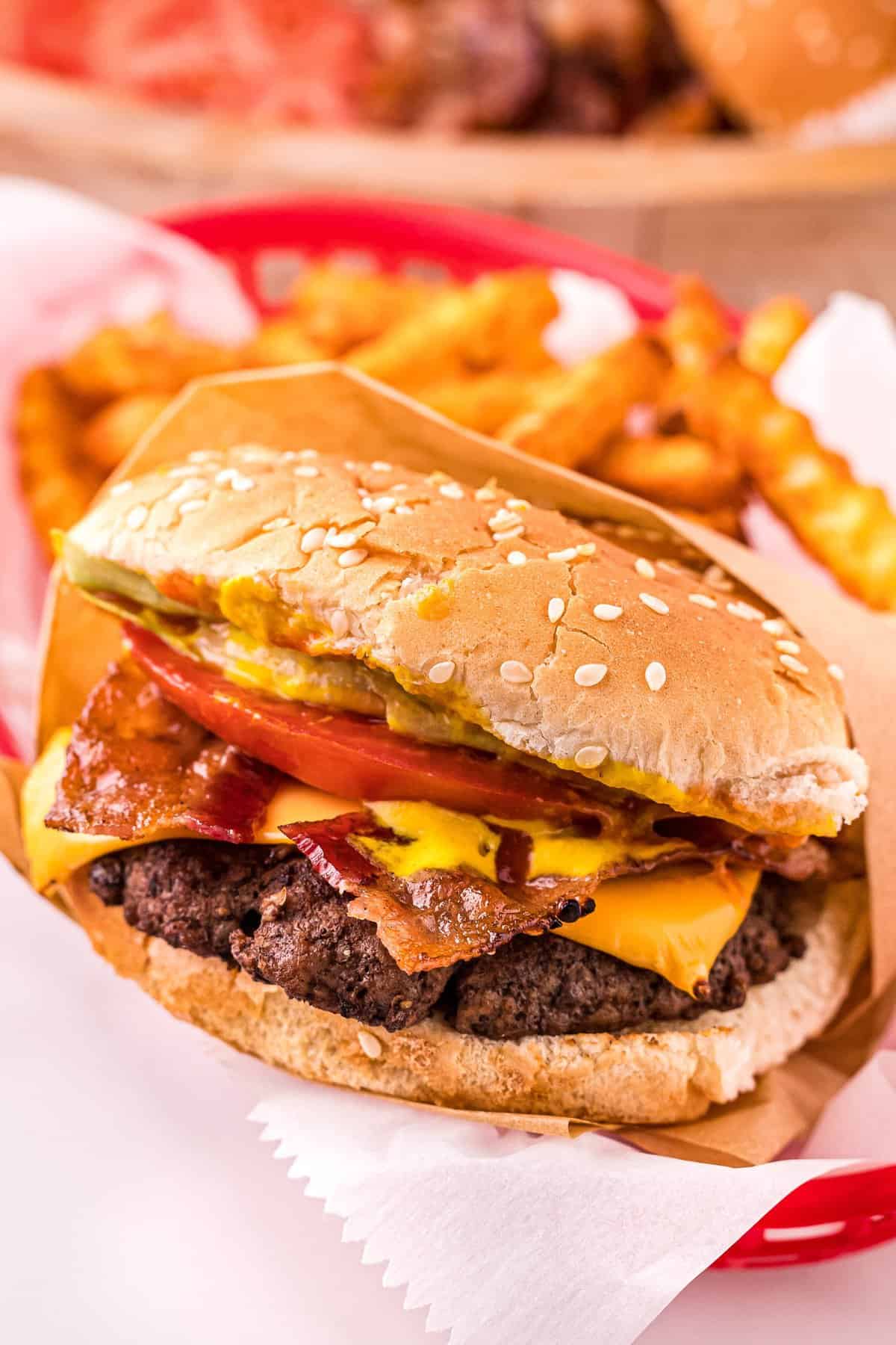 Hand holding a burger with toppings