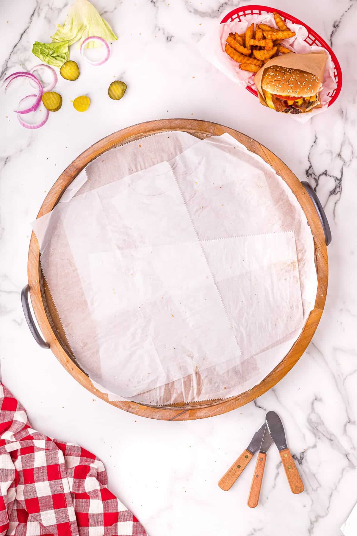 Overhead image of round wood platter with parchment paper