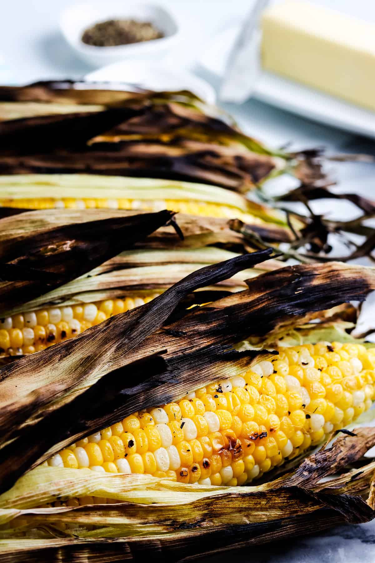 Pieces of grilled corn on the cob with husk
