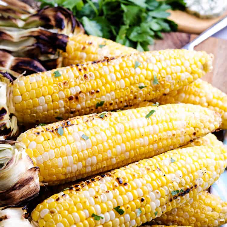 Grilled Corn on the Cob laying on a cutting board