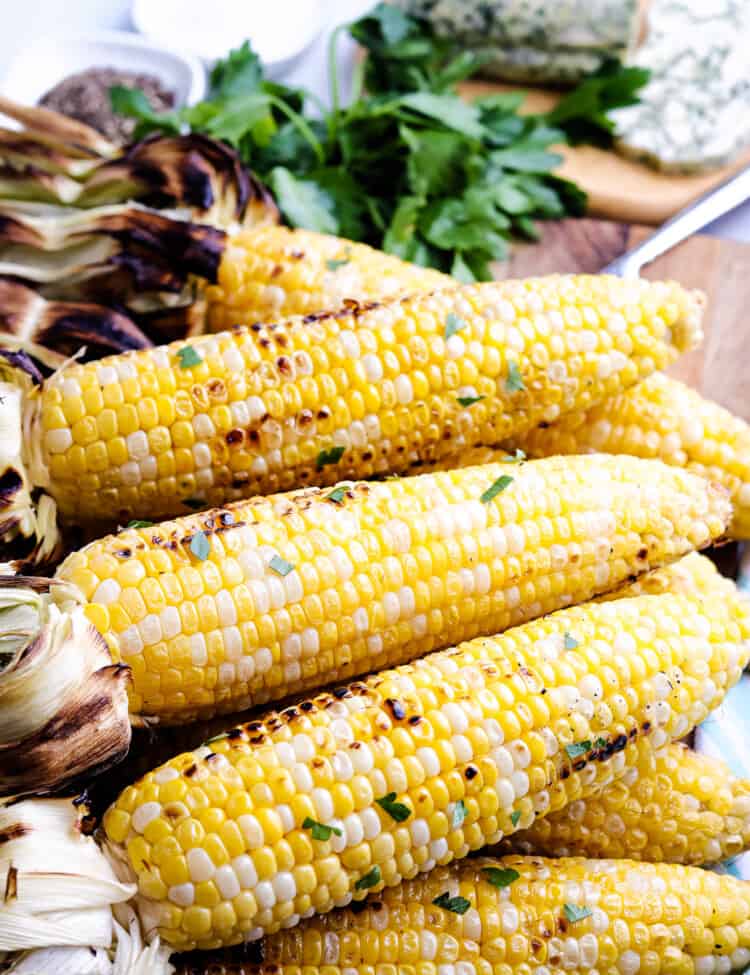 Grilled Corn on the Cob laying on a cutting board