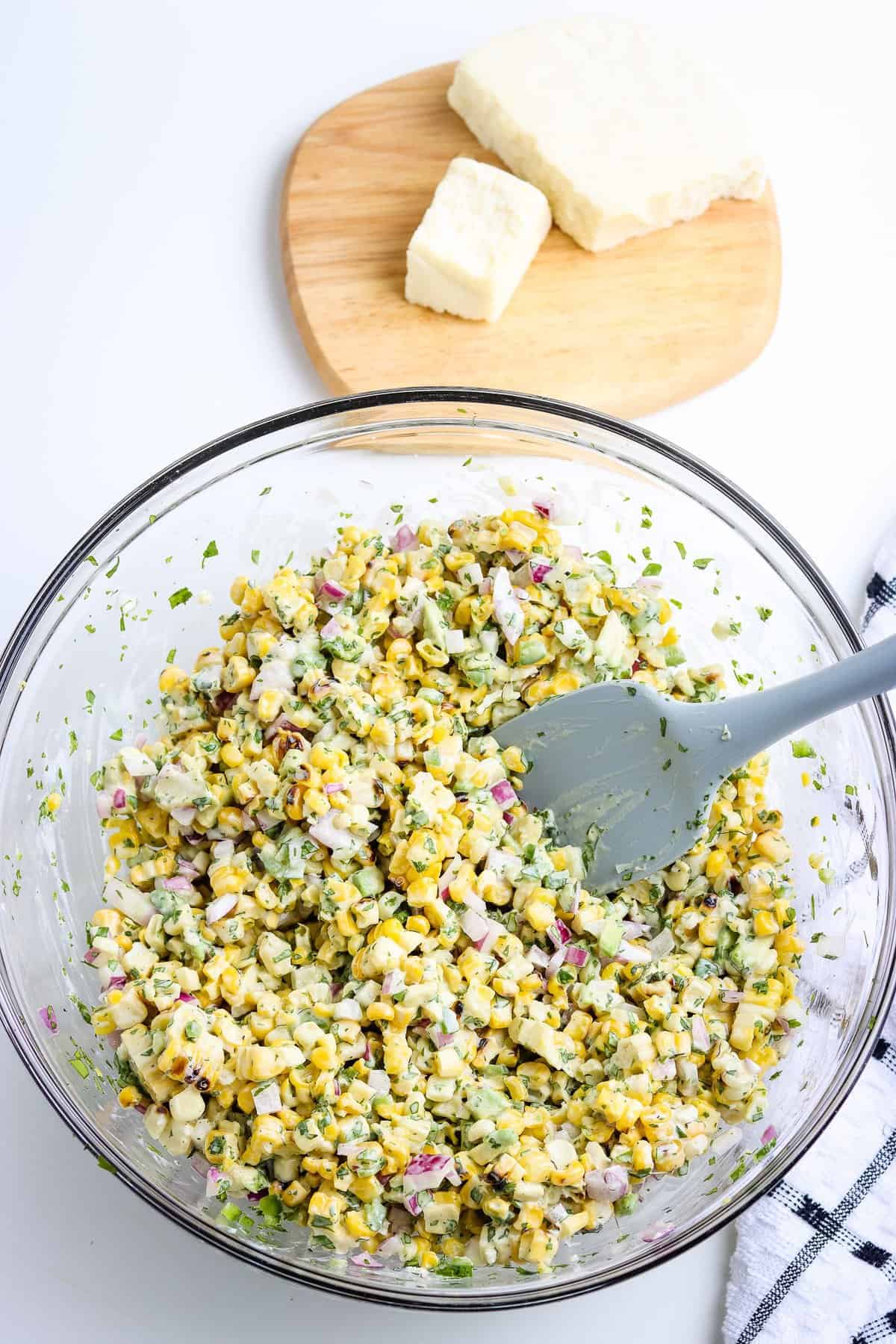 Glass bowl with Mexican Street Corn Salad Stirred up