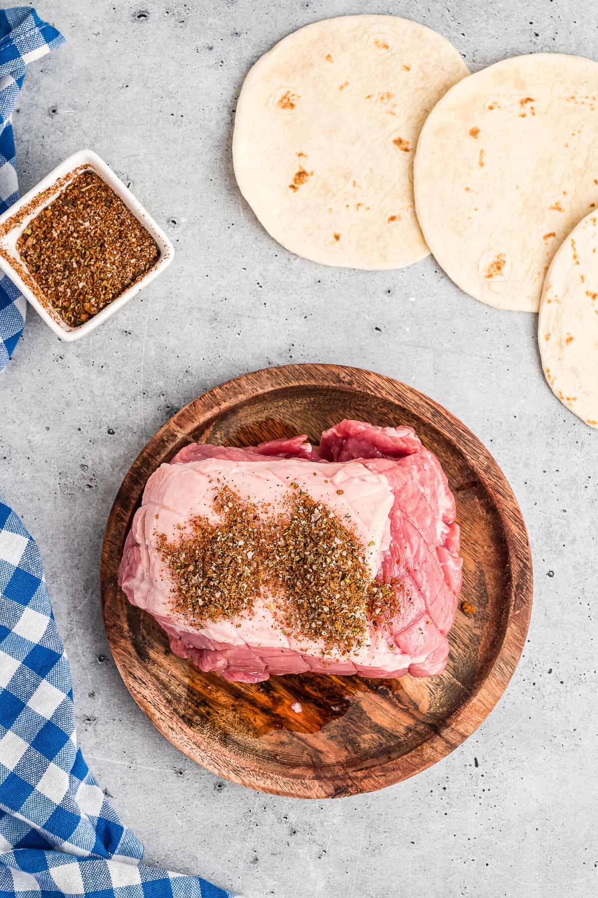 Rubbing pork shoulder with bbq rub