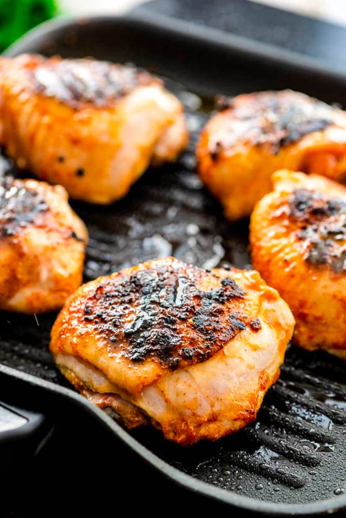 Grill pan with grilled chicken thighs