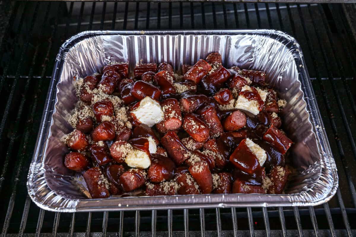 Placing Disposible Pan Back on Smoker for Hot Dog Burnt Ends Recipe