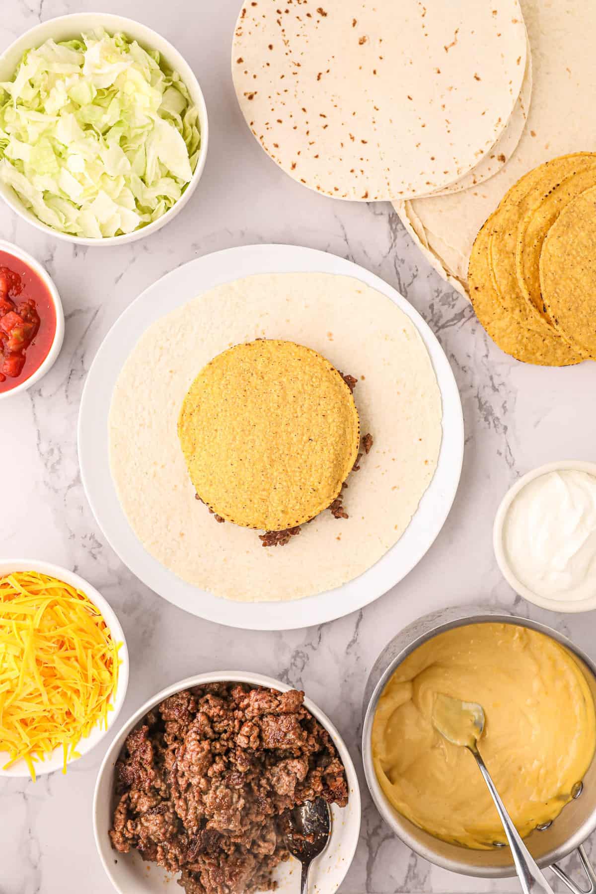Topping Blackstone Crunchwrap Ingredients with Tostada Shell