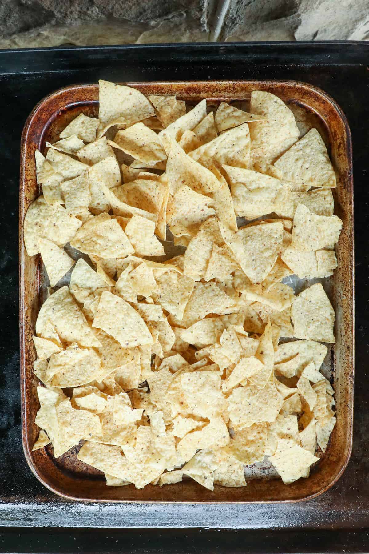 Tortilla chips on baking sheet for Blackstone Nachos