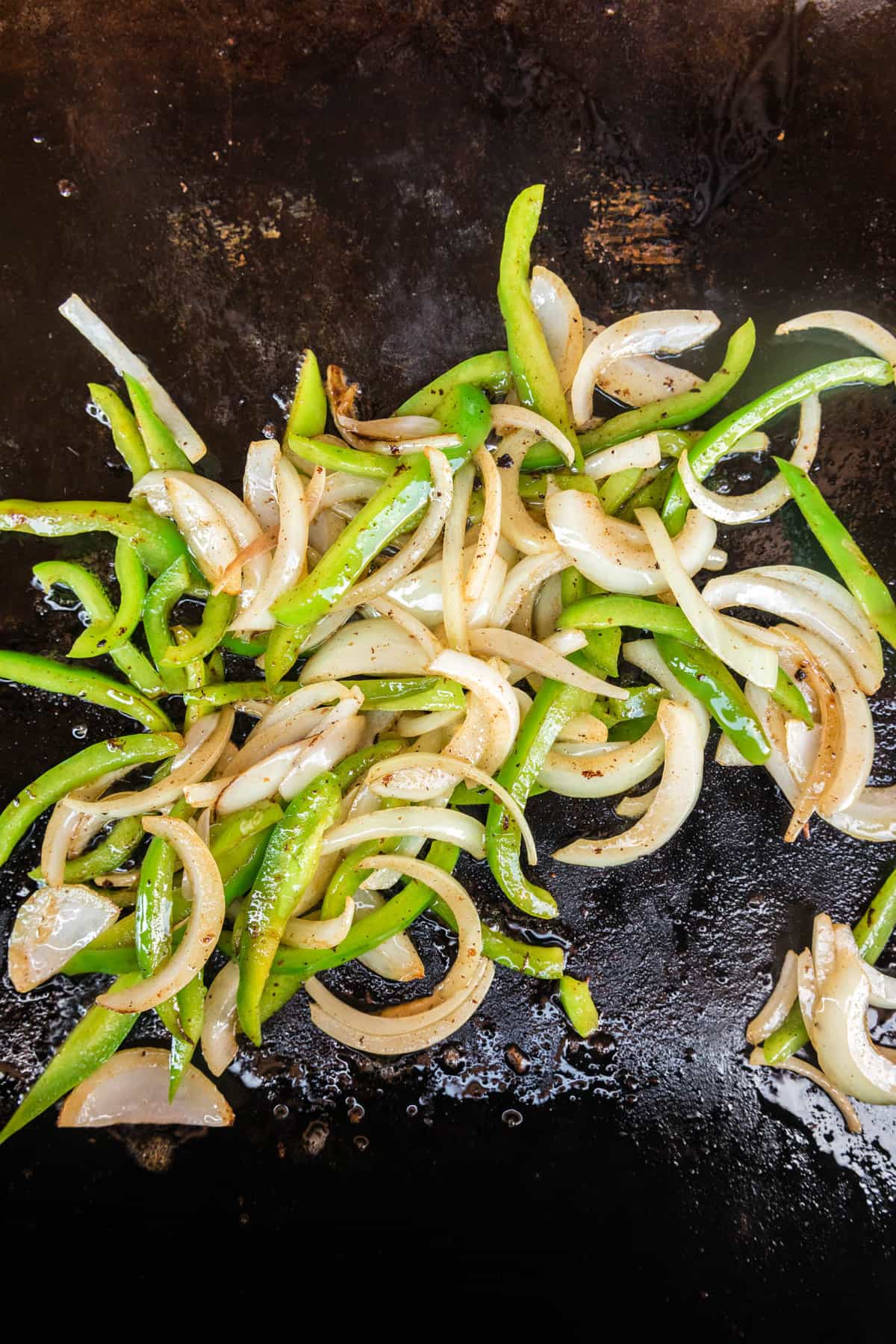 Thinly sliced onion and green pepper sauting on the Blackstone for Philly Cheesesteak on Blackstone