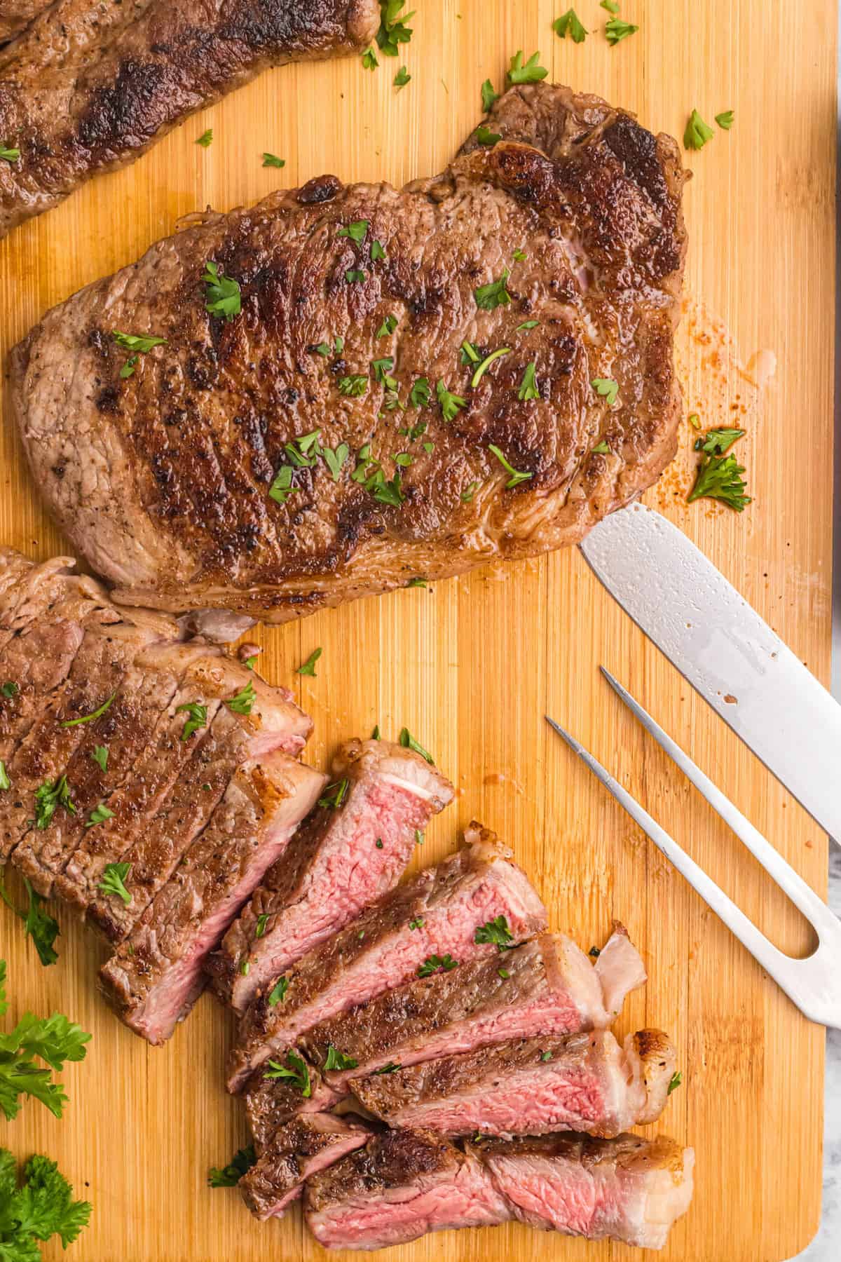 Slicing Blackstone Steaks on Wooden Cutting Board