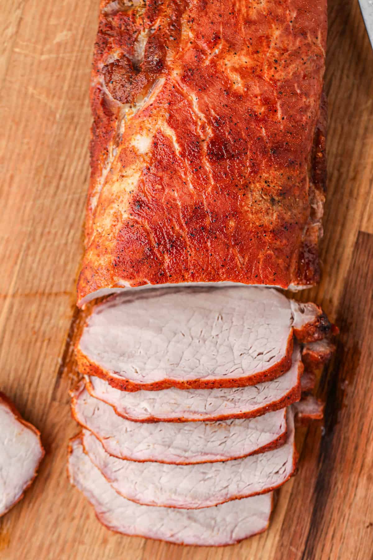 Slicing Grilled Pork Loin on wooden cutting board