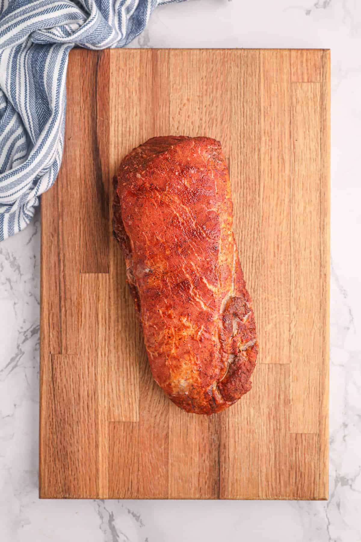 Allowing Grilled Pork Loin to cool on wooden cutting board before slicing