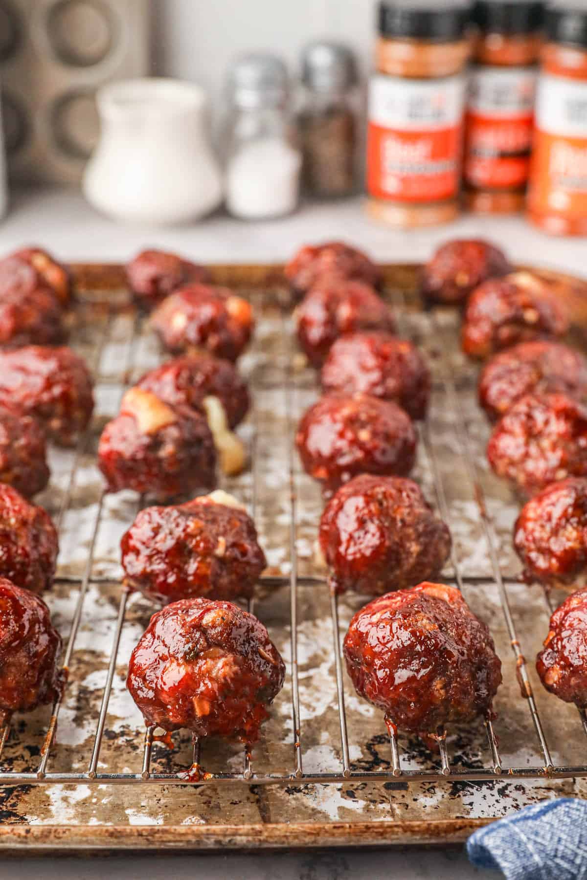 Smoked Cheese Stuffed Meatballs just out of the smoker on wire smoking rack 