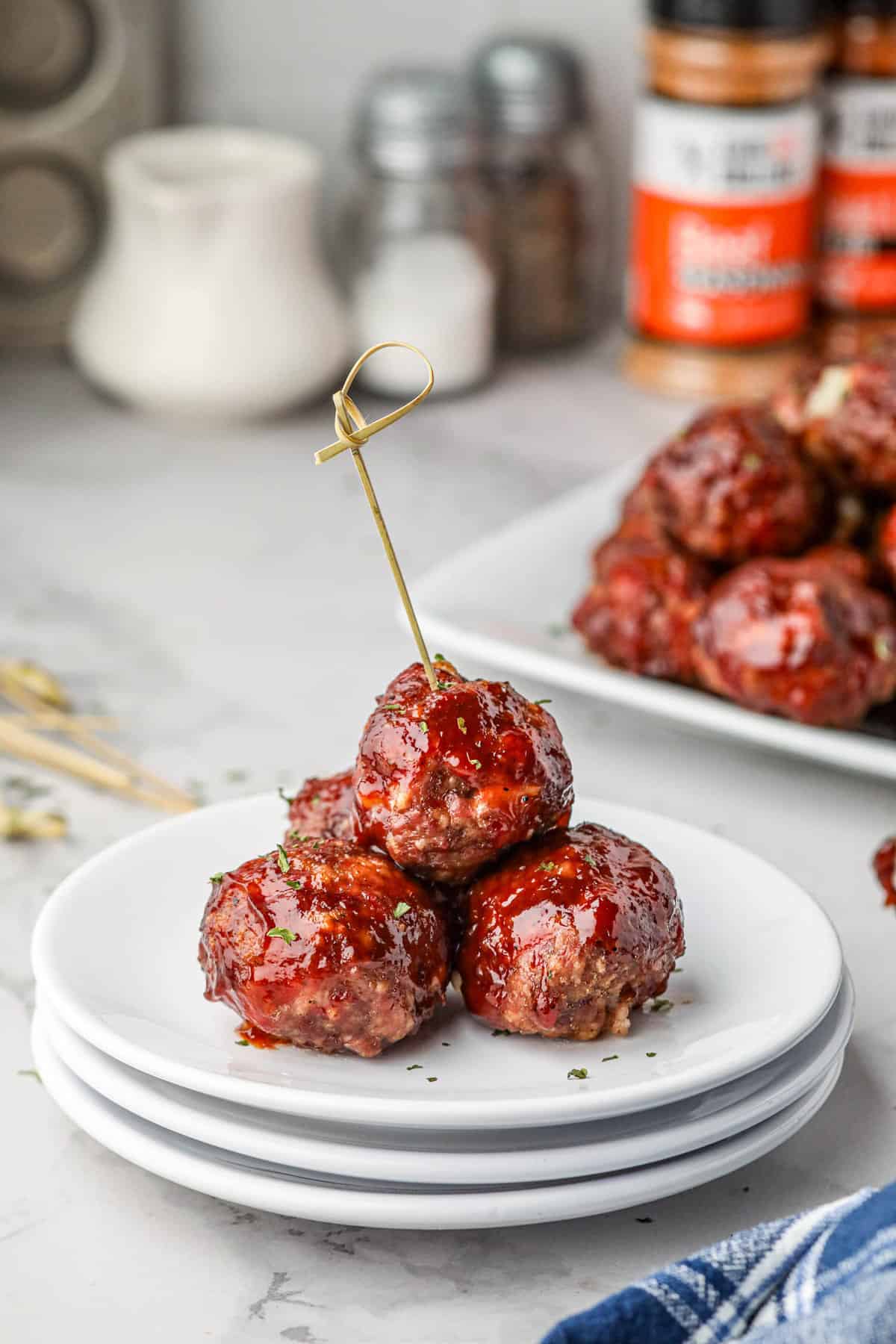 Smoked Stuffed Meatballs stacked on plate with food pick