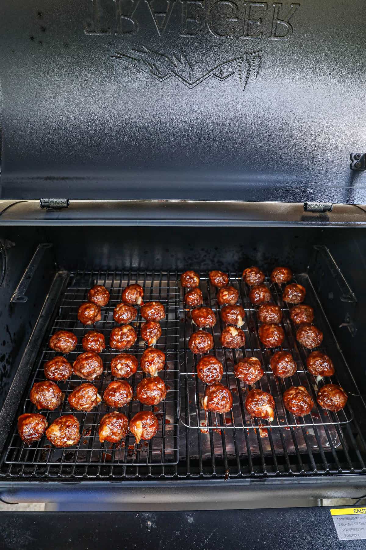 Sauce brushed onto meatballs in smoker for Smoked Cheese Stuffed Meatballs recipe