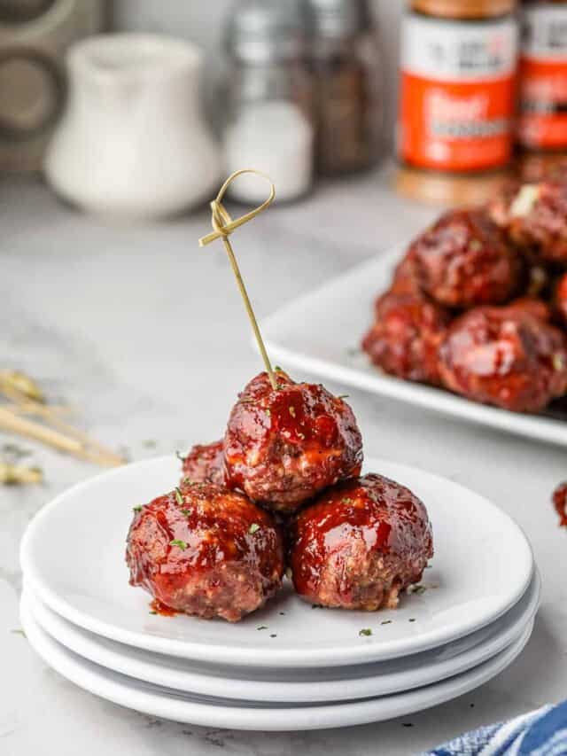 Smoked Stuffed Meatballs stacked on plate with food pick