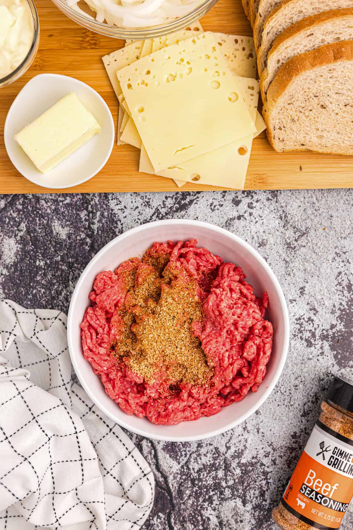 Combining ground beef with beef seasoning for Blackstone Patty Melt recipe