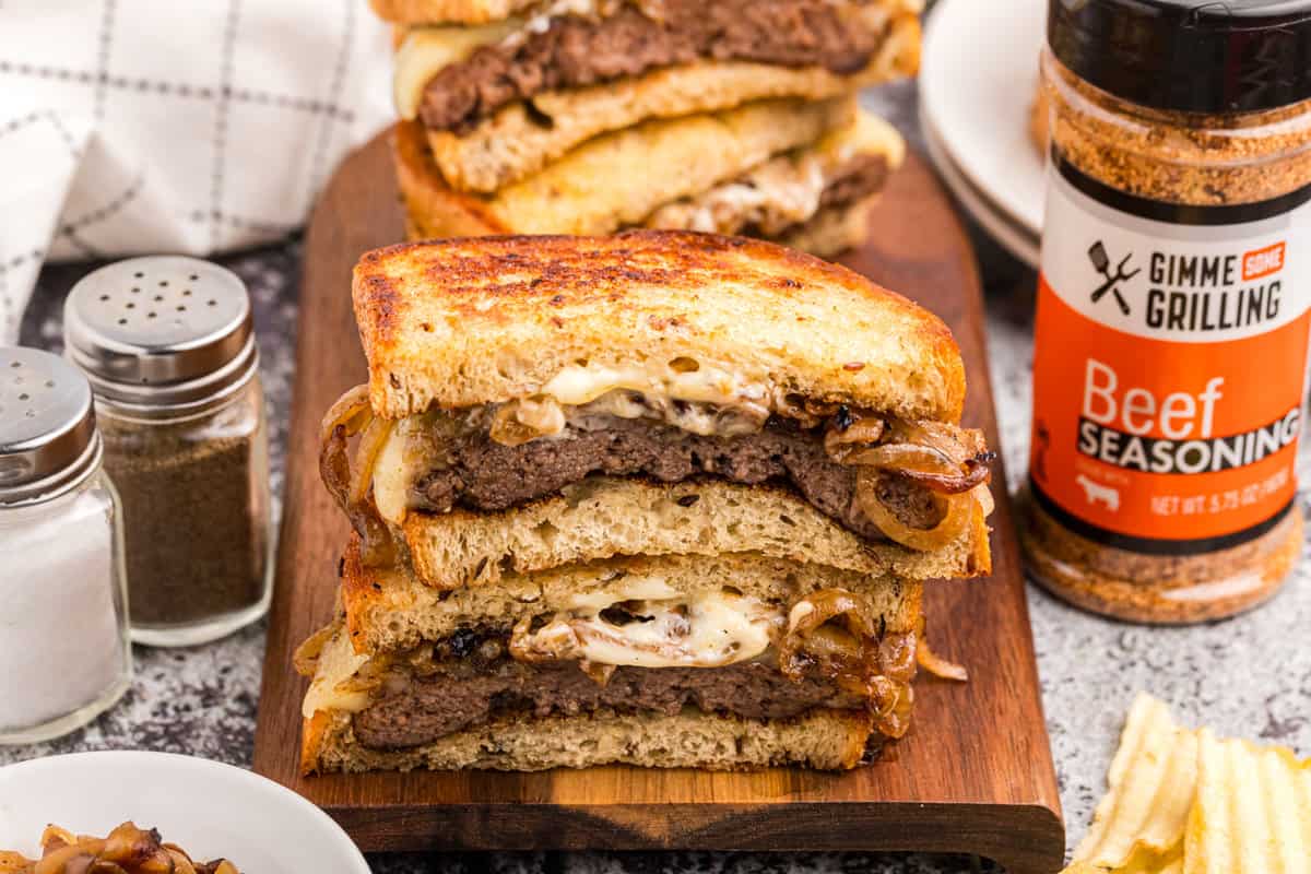 Blackstone Patty Melts cut and stacked on cutting board