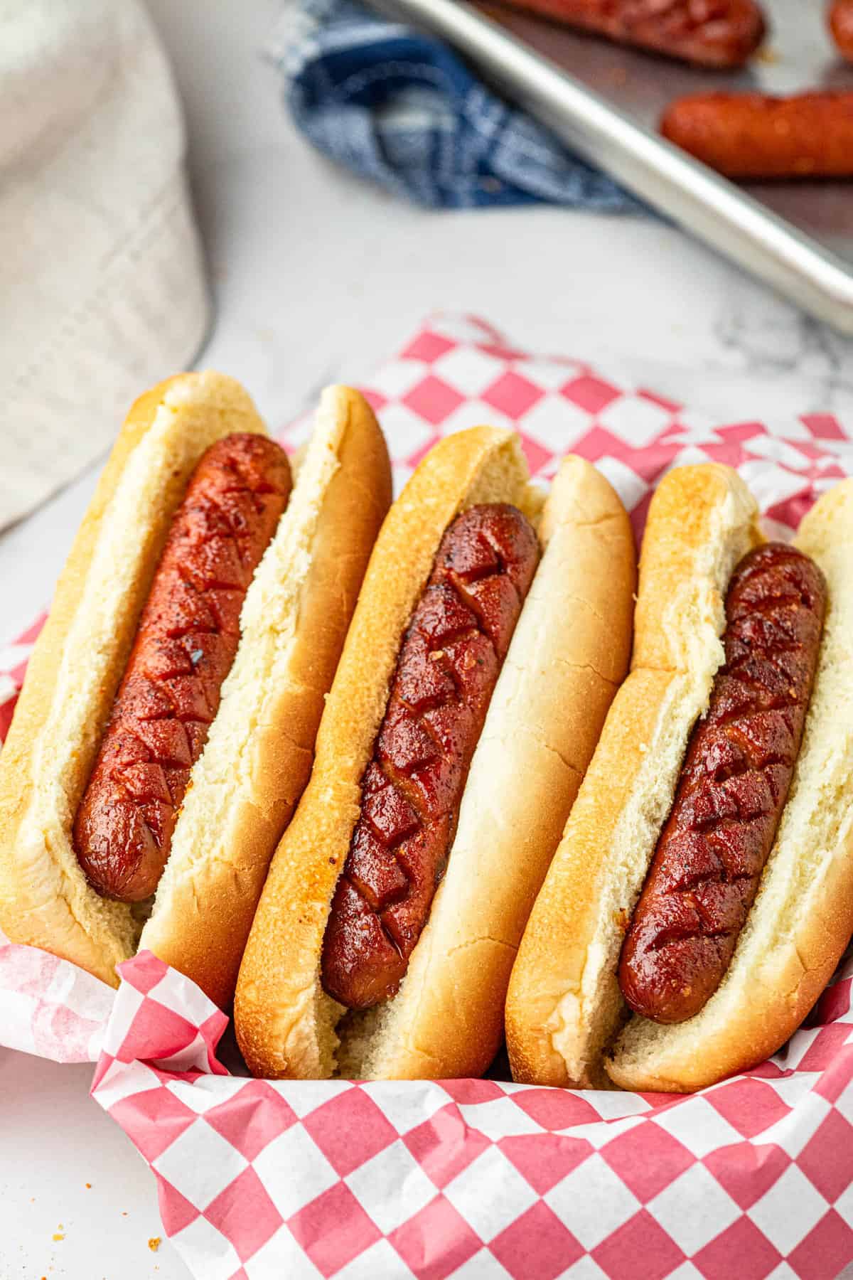 Smoked Hot Dogs in bun lined in serving basket