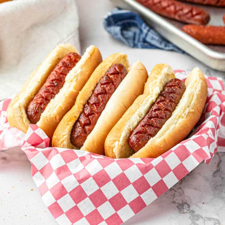 Smoked hot dogs in bun arranged in serving paper-ilned baskets