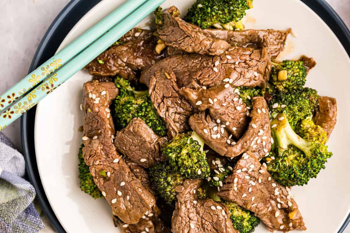 Blackstone Beef & Broccoli in shallow bowl with chopsticks