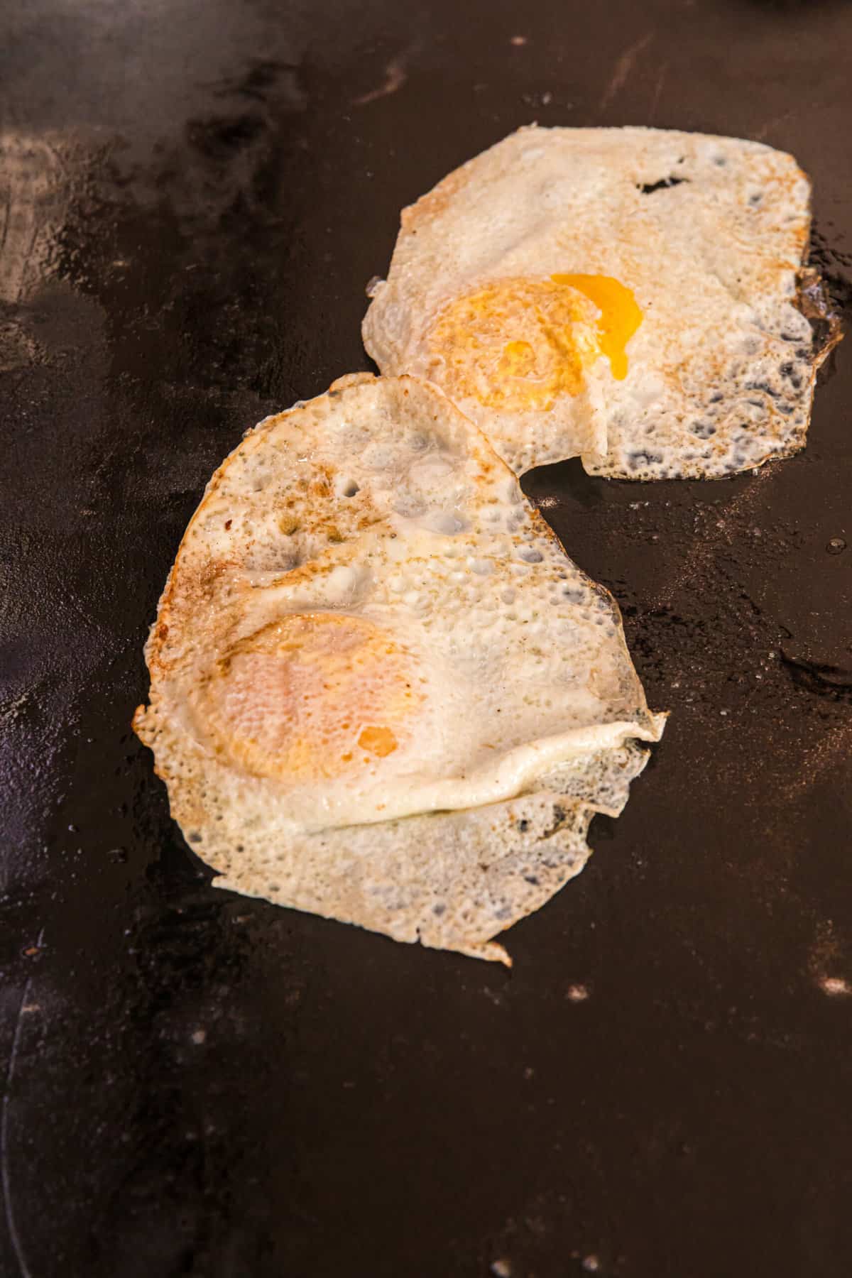 Blackstone Fried Egg flipped to other side for cooking on griddle