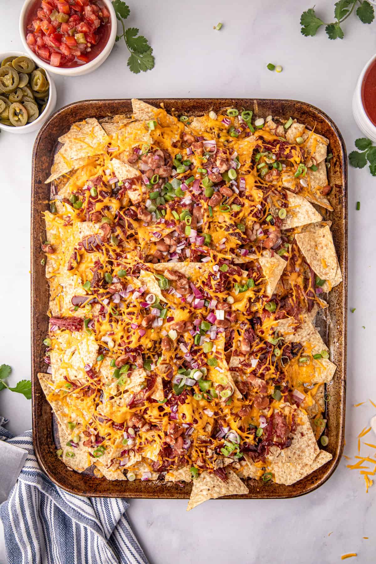 Beef Brisket Nachos Recipe on baking sheet ready to load up with extra toppings
